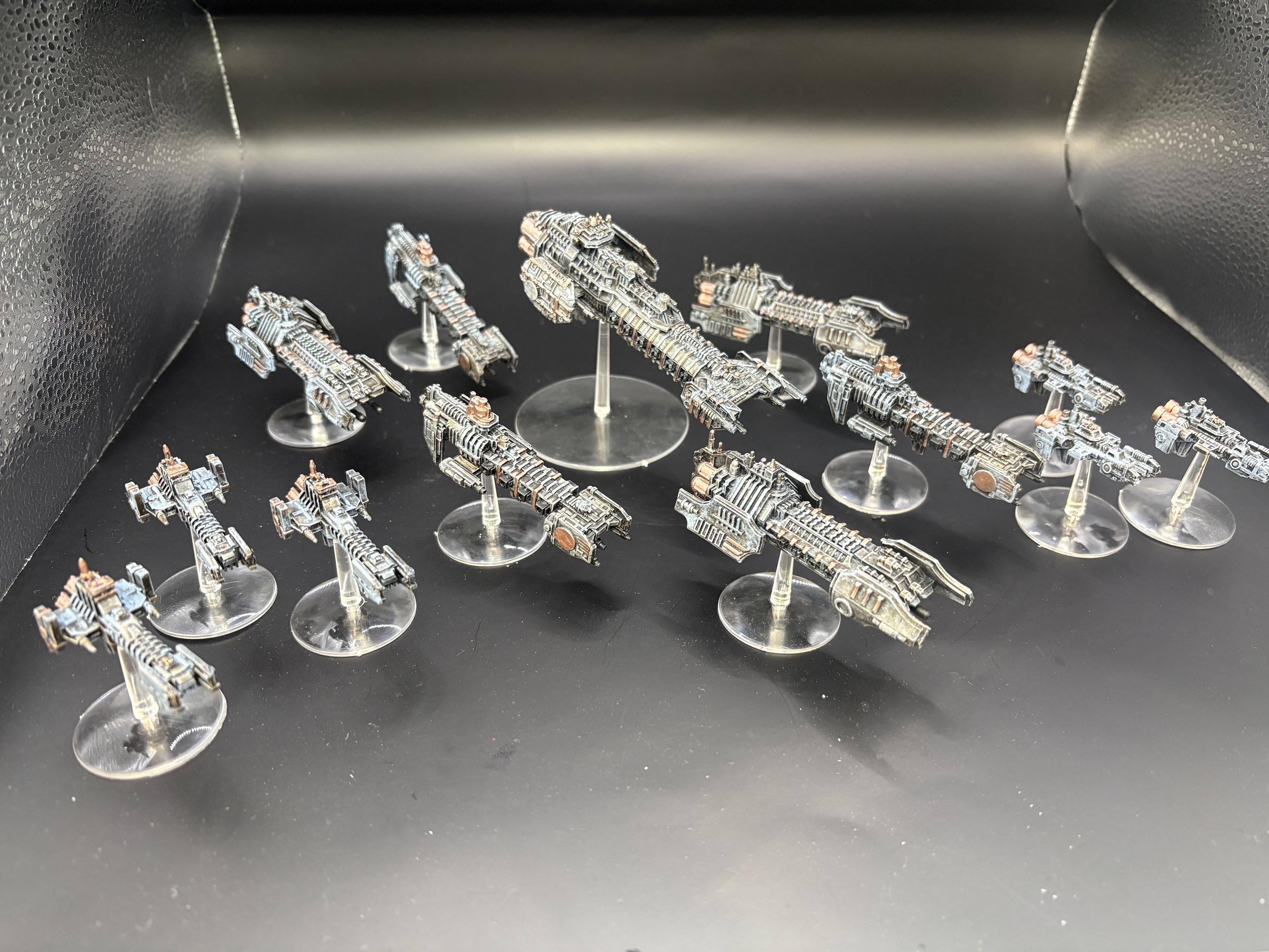 A fleet of spaceships wolves ship including a battle barge several strike cruisers and and two squadrons of escorts