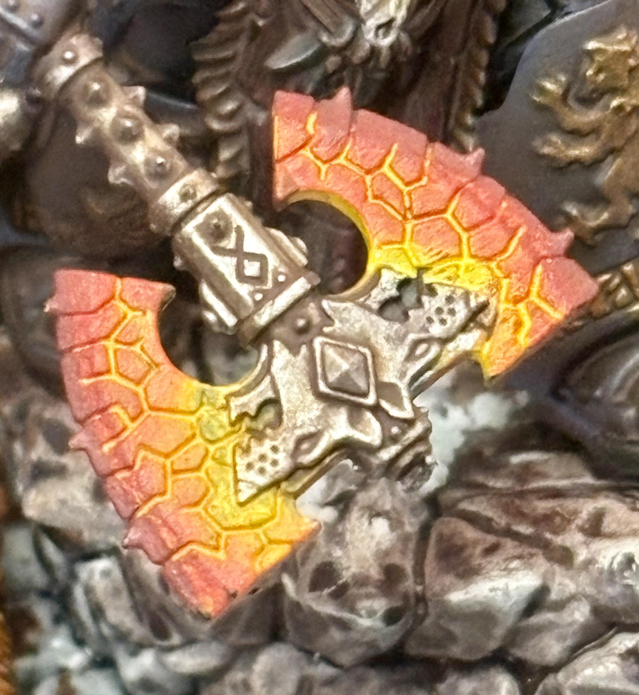 Close up on Logan Griman’s axe, showing a smooth gradient from yellows through oranges to dark red